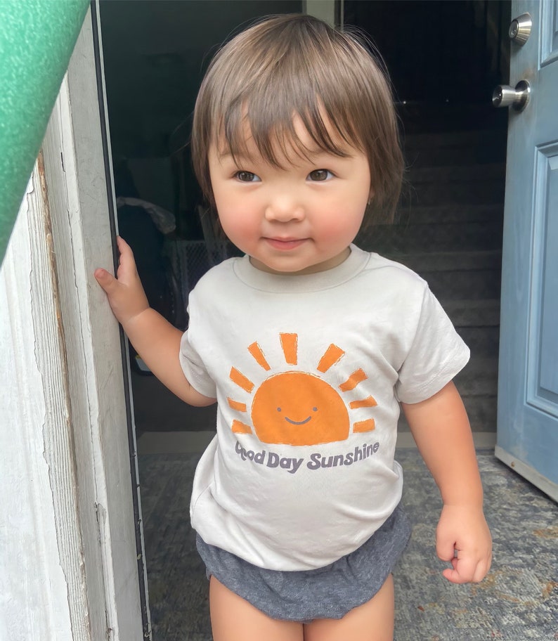 Kid t-shirt with sun design that says "Good Day Sunshine."