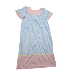 May include: A calf-length nightgown featuring a square neckline and short sleeves. The garment is made of light blue and white pinstriped fabric, with a pink and white pinstriped yoke and hem, accented by thin yellow trim at the seams.