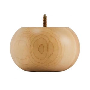 May include: A light-colored, round wooden furniture leg with a screw protruding from the top. The leg has a smooth, polished finish and visible wood grain patterns. This furniture component is designed for easy attachment to various furniture pieces.