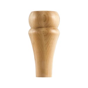 May include: A wooden furniture leg with a rounded top and a tapered bottom. The leg is made of light-colored wood and has a smooth finish.