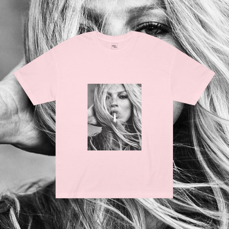 May include: A pink t-shirt with a black and white image of a woman with long hair smoking a cigarette.