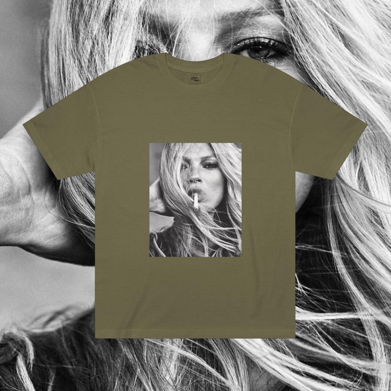 May include: A green t-shirt with a black and white photo of a woman with long hair smoking a cigarette.