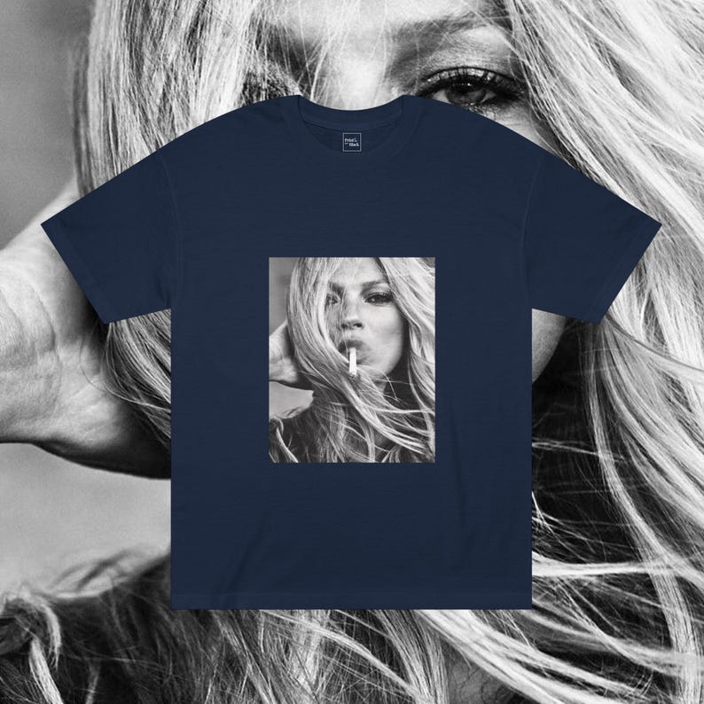 May include: A navy blue t-shirt with a black and white photo of a woman with long hair smoking a cigarette.