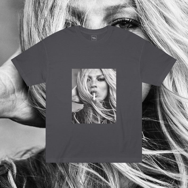 May include: A dark gray t-shirt with a black and white photo of a woman with long hair smoking a cigarette.