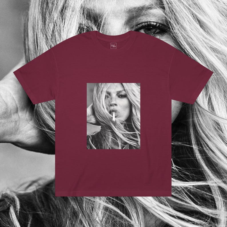 May include: A maroon t-shirt with a black and white photo of a woman with long hair smoking a cigarette.
