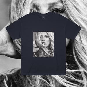 May include: A navy blue t-shirt with a black and white photo of a woman with long blonde hair smoking a cigarette.