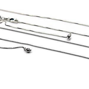 May include: Two silver chains, one with an adjustable clasp, the other with a fixed length.