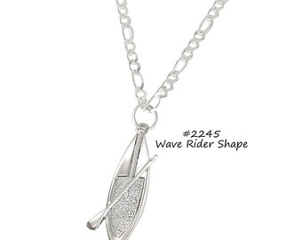 May include: A silver-toned necklace featuring a pendant shaped like a canoe with an attached paddle. The pendant hangs from a chain with a textured link design. The text "#2245 Wave Rider Shape" is visible.