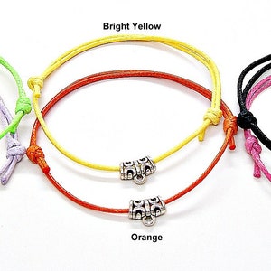 May include: Six colourful bracelets with silver toggle clasps. The bracelets are in the colours lime green, lavender, bright yellow, orange, black, and bright pink.