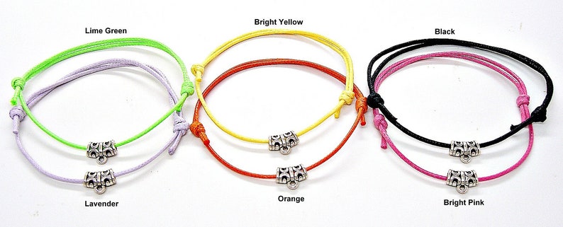 May include: Six colourful bracelets with silver toggle clasps. The bracelets are in the colours lime green, lavender, bright yellow, orange, black, and bright pink.