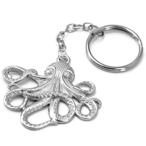 May include: A silver octopus keychain with a detailed design and a silver key ring.