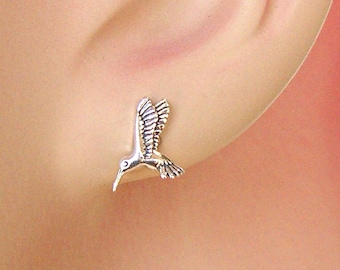 May include: Sterling silver hummingbird stud earrings. The earrings feature a detailed hummingbird design with delicate wings.