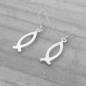 May include: A pair of silver fish symbol earrings with a simple design. The earrings are made of metal and have a hook fastening.