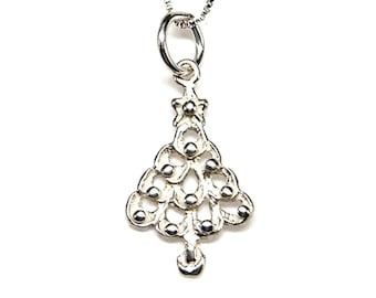 May include: A silver pendant necklace with a Christmas tree design. The pendant is a stylised tree shape with small, round accents and a star at the top. The necklace has a delicate chain.