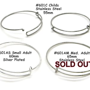 May include: Four silver bangle bracelets, two with a silver plated finish and two with a stainless steel finish. The bracelets are available in three sizes: 55mm, 60mm, and 65mm. The 65mm bracelet is sold out.