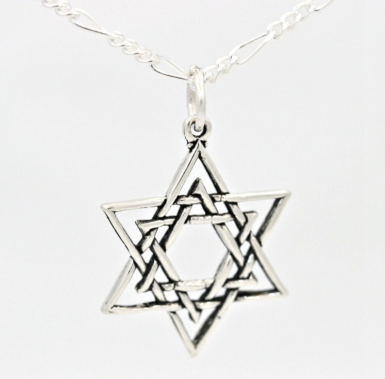 May include: A silver chain necklace with a silver Star of David pendant. The pendant is a detailed, intricate design of interwoven triangles.