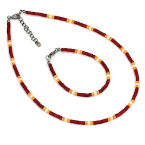 May include: A set of red, orange, and white beaded jewelry, including a necklace and a bracelet. The necklace has a silver clasp.