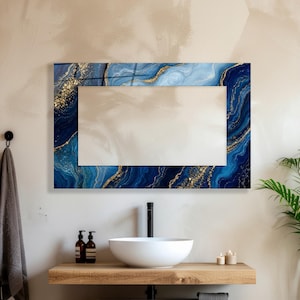 May include: A rectangular wall mirror featuring a decorative frame with a blue and white marble pattern accented by gold flecks. The mirror has a clear, reflective center surface and is mounted horizontally above a bathroom vanity area.