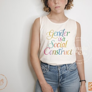 May include: A white tank top with the text "Gender is a Social Construct" in rainbow colors. The text is in a stylized font.