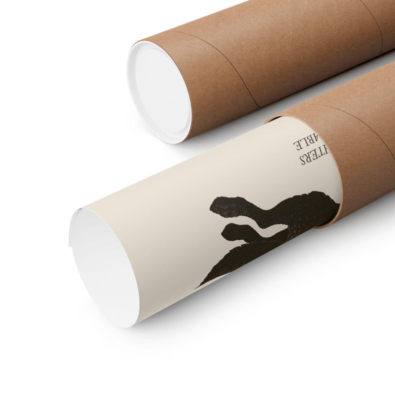 May include: Two brown cardboard poster tubes, one open, revealing a rolled-up poster. The poster has a beige background with a black abstract design and the word "MATTERS" printed in black. The tubes are on a white surface.