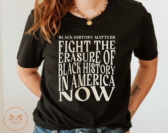 May include: Black t-shirt with the text "BLACK HISTORY MATTERS FIGHT THE ERASURE OF BLACK HISTORY IN AMERICA NOW" printed in white.