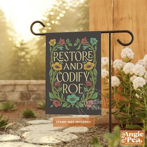 May include: A garden flag with a dark background and floral border. The text "RESTORE AND CODIFY ROE" is written in a colorful font.