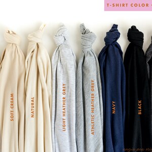 May include: T-shirt color guide showing ten different colors of t-shirts: white, soft cream, natural, light heather grey, athletic heather grey, navy, black, dark heather grey.