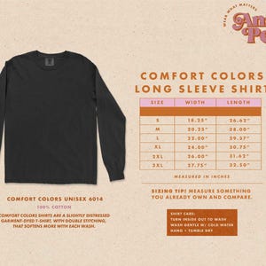 May include: A black long-sleeve shirt with the text "Comfort Colors Long Sleeve Shirt" and a size chart in inches. The shirt is made of 100% cotton and is slightly distressed.