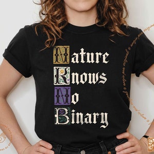 May include: Black t-shirt with the text "Nature Knows No Binary" in white lettering. The text is in a decorative font with each letter framed in a colorful square.