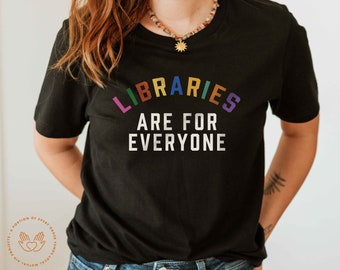 May include: A black t-shirt with the text "LIBRARIES ARE FOR EVERYONE" in a rainbow arc. The text is in white and the background is black.