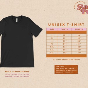 May include: Unisex t-shirt size chart with measurements in inches. The chart shows sizes S through 4XL with corresponding width and length measurements. The chart is on a pink background with a brown border.