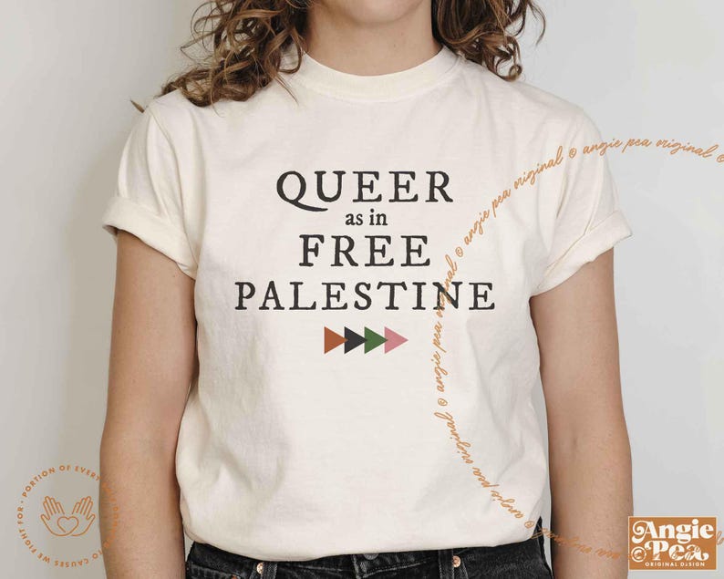 May include: A white t-shirt with the text "QUEER as in FREE PALESTINE" in black lettering. A row of colorful geometric shapes are below the text.