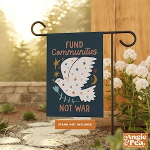 May include: A blue garden flag with a white dove and stars. The text on the flag reads "FUND Communities NOT WAR".