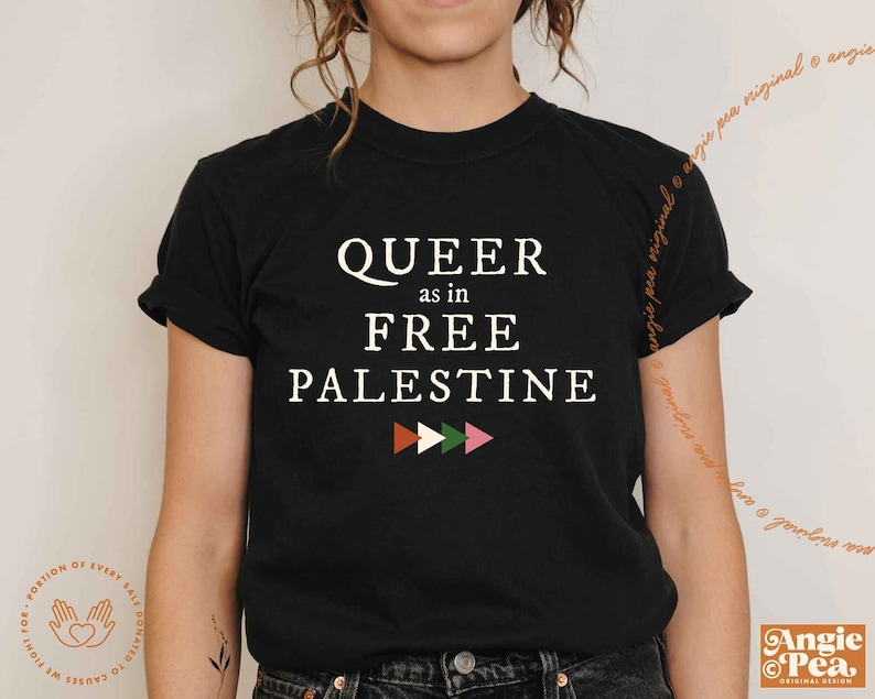 May include: Black t-shirt with white text that reads "QUEER as in FREE PALESTINE" with a row of three colorful triangles below the text.