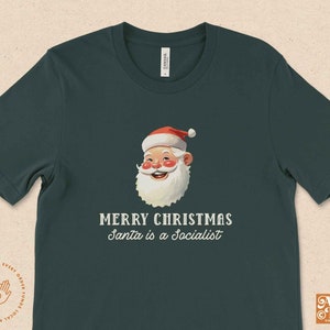 May include: A dark green t-shirt with a vintage illustration of Santa Claus and the text "Merry Christmas Santa is a Socialist".