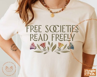 May include: A white t-shirt with the text "FREE SOCIETIES READ FREELY" in green lettering. The text is surrounded by a row of colourful flowers with green leaves.