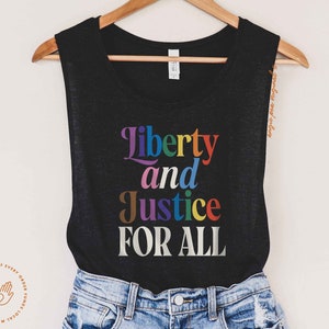 May include: A black tank top with the text "Liberty and Justice FOR ALL" in rainbow colors.
