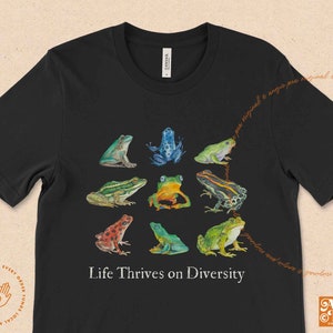 May include: Black t-shirt with a graphic of nine colorful frogs arranged in a circle. The text "Life Thrives on Diversity" is printed below the frogs.