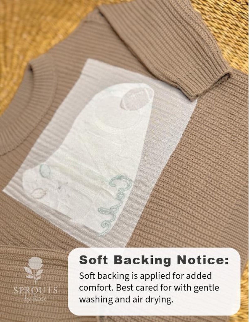 May include: A tan knitted sweater with a ribbed design. A white, textured backing is applied for comfort. The image includes the text "Soft Backing Notice" and care instructions for gentle washing and air drying.