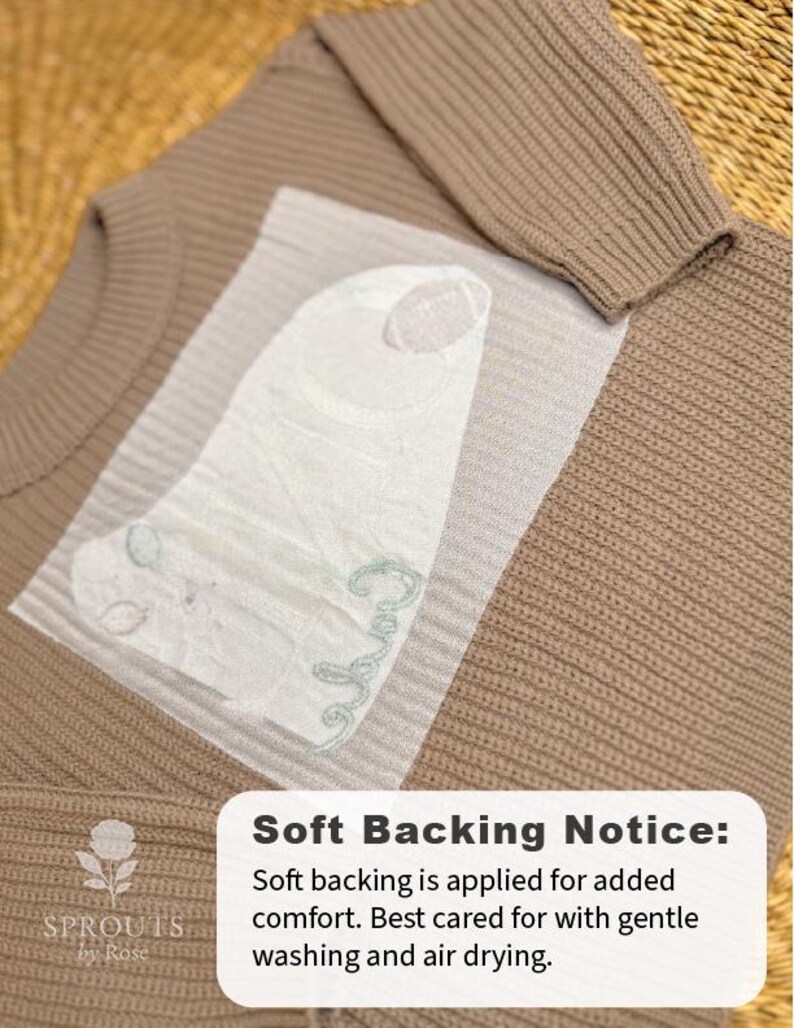 May include: A close-up of a tan sweater with a ribbed texture. A white, textured backing is applied to the sweater for added comfort. The text "Soft Backing Notice" is visible, along with care instructions.