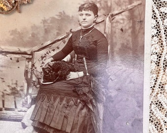 Victorian Women Holding Feathered Hat and Umbrella