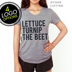 May include: A heather grey t-shirt with a black graphic that reads "Lettuce Turnip The Beet".