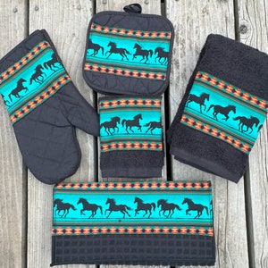 May include: Set of four kitchen towels and a pot holder featuring a turquoise and black design with a silhouette of horses running. The design includes a geometric pattern in orange, red, and white.