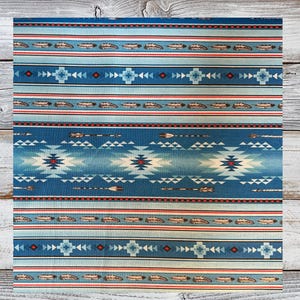 May include: Blue and red fabric with a Native American inspired pattern. The pattern features feathers, arrows, and geometric shapes.