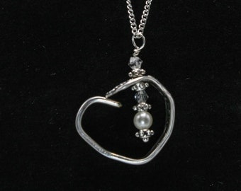 May include: A silver heart-shaped pendant necklace with a pearl and crystal accents.