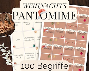 Pode incluir: Um jogo com tema natalino com as palavras "WEIHNACHTS PANTOMIME". O jogo inclui cartas com palavras e imagens relacionadas ao Natal, com o texto "100 Begriffe" na parte inferior. O jogo é em alemão.