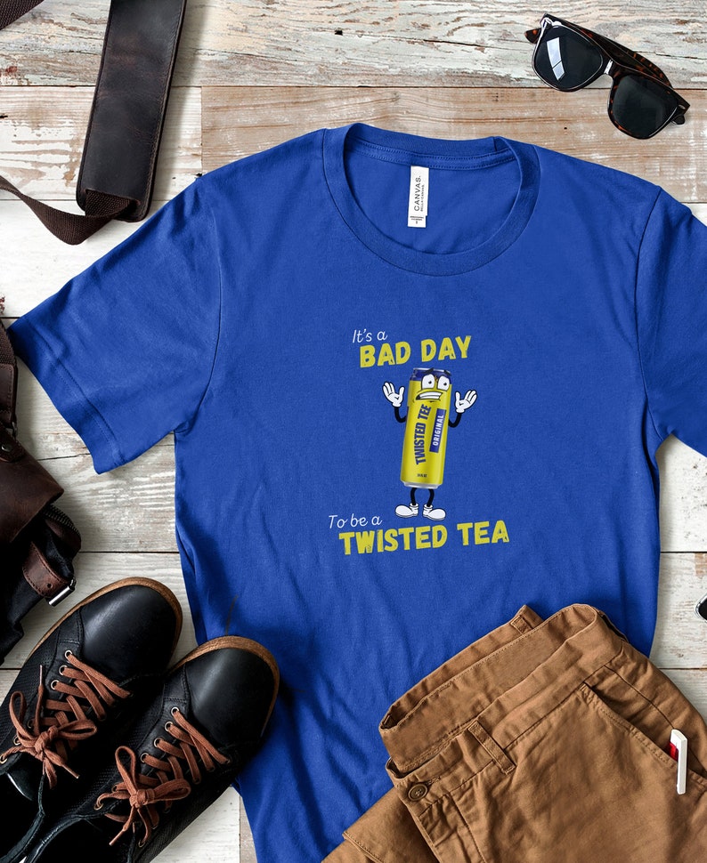 May include: A blue t-shirt with a yellow cartoon can of Twisted Tea. The can has a face and arms and is holding up two fingers. The text on the shirt reads "It's a bad day to be a Twisted Tea."