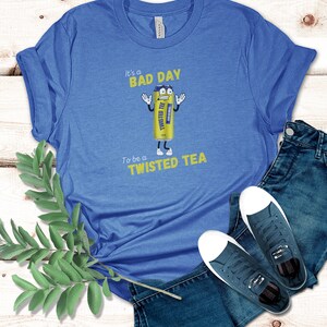 May include: Blue t-shirt with a graphic of a cartoon Twisted Tea can with the text "It's a bad day to be a Twisted Tea".