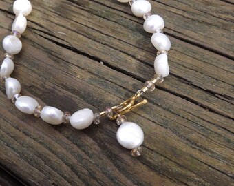 White Coin Pearl necklace with crystal beads.Necklace is lovely, very feminine.You can wear it with clasp at th