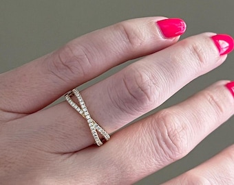 May include: A gold ring with a criss-cross design, set with small diamonds.